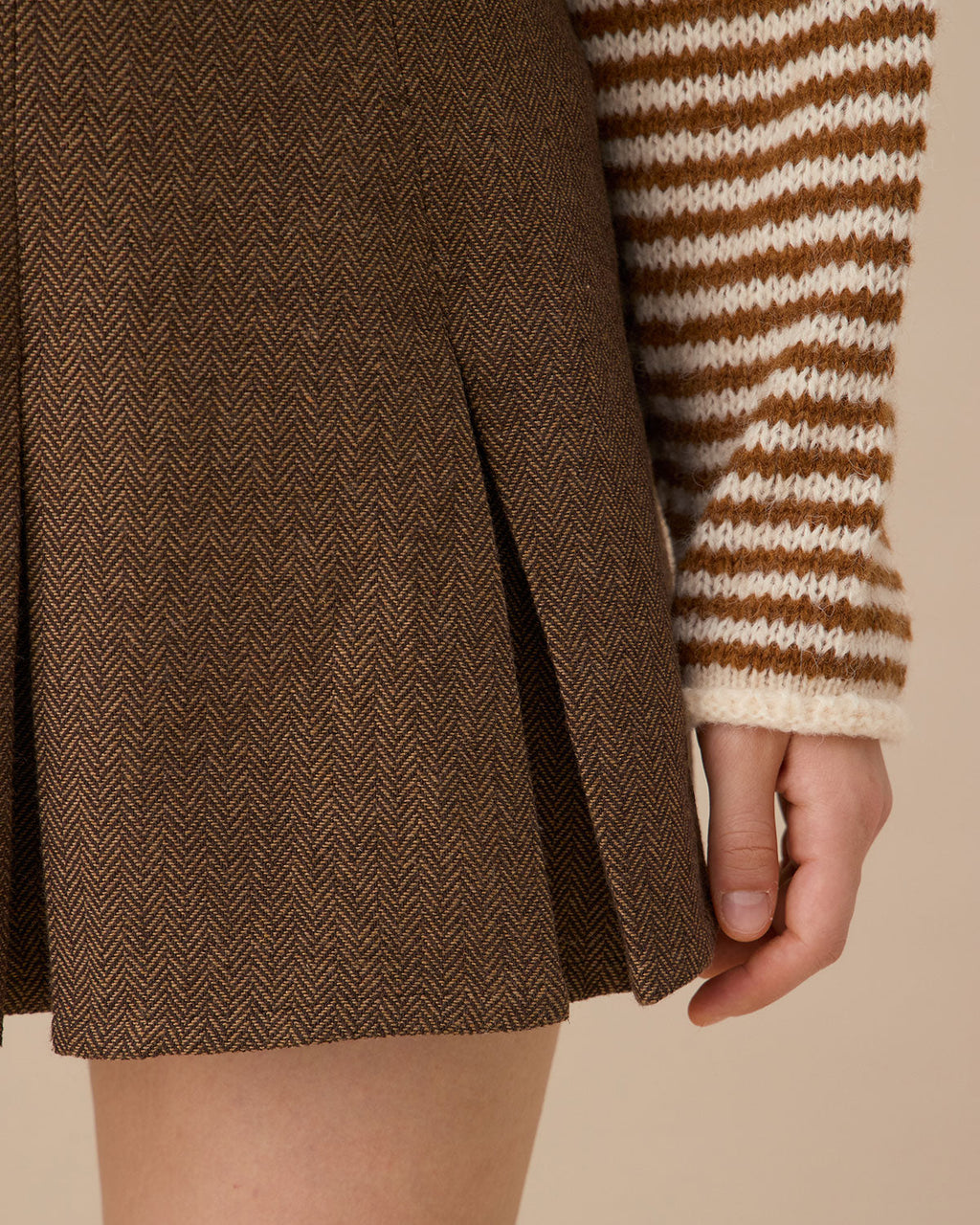 Brown Striped Pleated Mini Skirt" can be rewritten as "Striped Mini Skirt with Pleats in Brown.