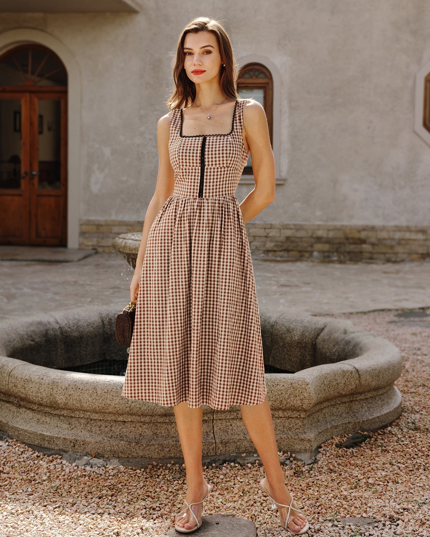Brown Plaid Sleeveless Midi Dress" can be rewritten as "Sleeveless Midi Dress in Brown Plaid" or "Brown Plaid Midi Dress Without Sleeves.