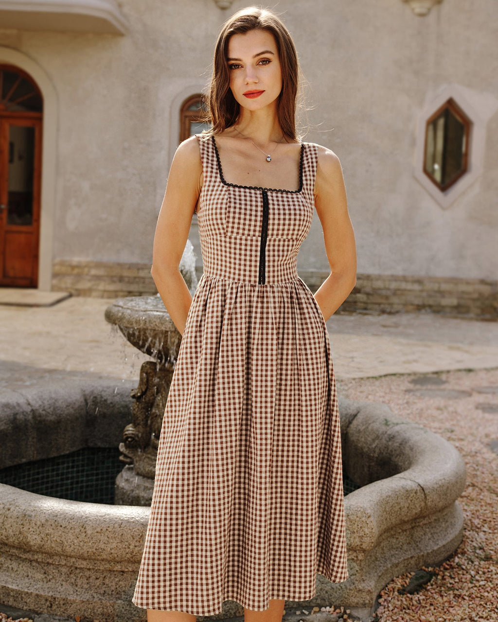 Brown Plaid Sleeveless Midi Dress" can be rewritten as "Sleeveless Midi Dress in Brown Plaid" or "Brown Plaid Midi Dress Without Sleeves.