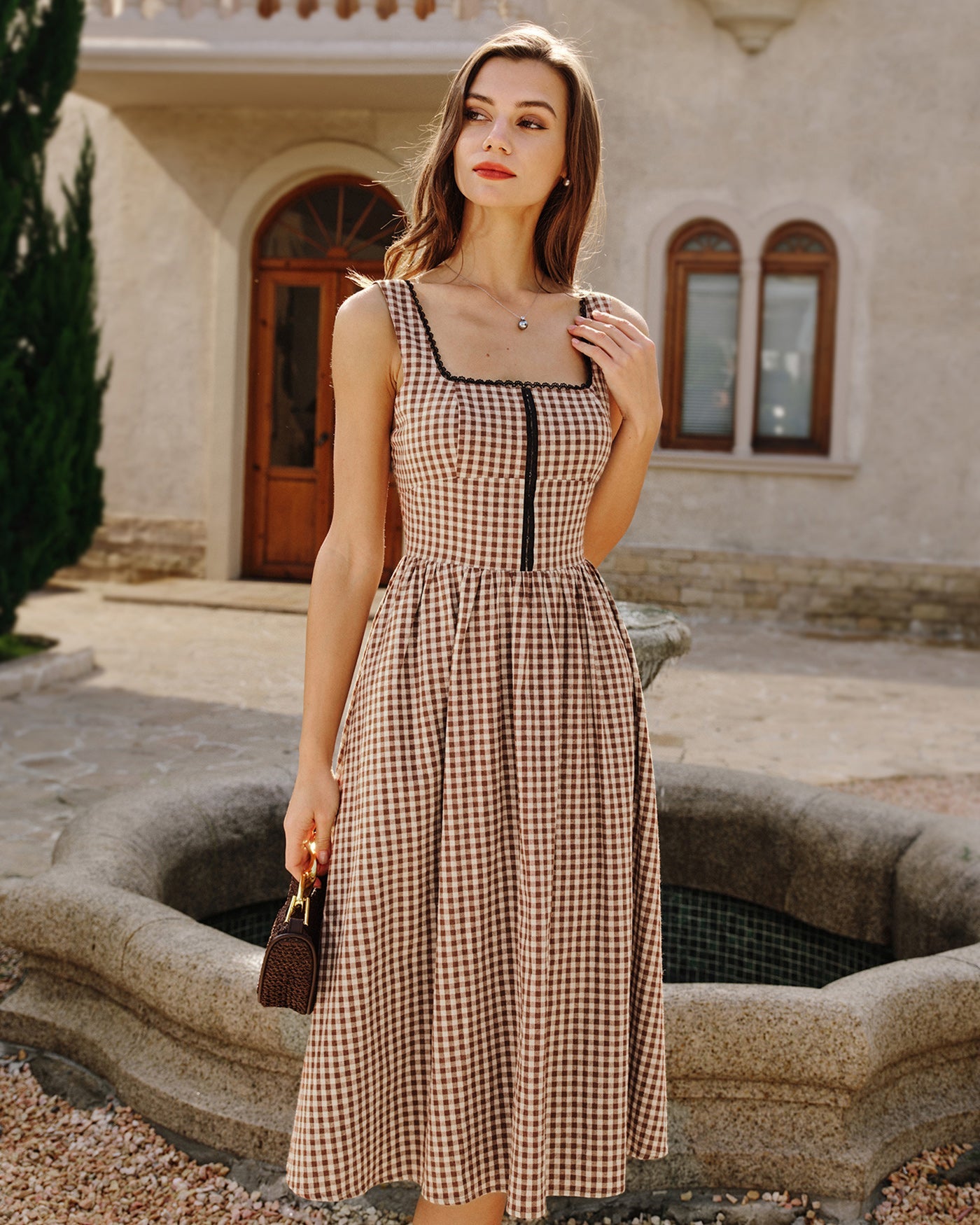 Brown Plaid Sleeveless Midi Dress" can be rewritten as "Sleeveless Midi Dress in Brown Plaid" or "Brown Plaid Midi Dress Without Sleeves.