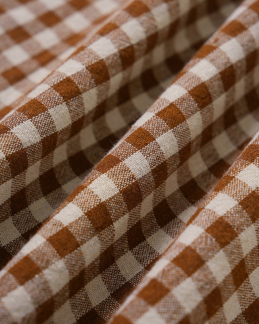 Brown Plaid Sleeveless Midi Dress" can be rewritten as "Sleeveless Midi Dress in Brown Plaid" or "Brown Plaid Midi Dress Without Sleeves.