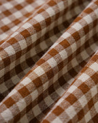 Brown Plaid Sleeveless Midi Dress" can be rewritten as "Sleeveless Midi Dress in Brown Plaid" or "Brown Plaid Midi Dress Without Sleeves.
