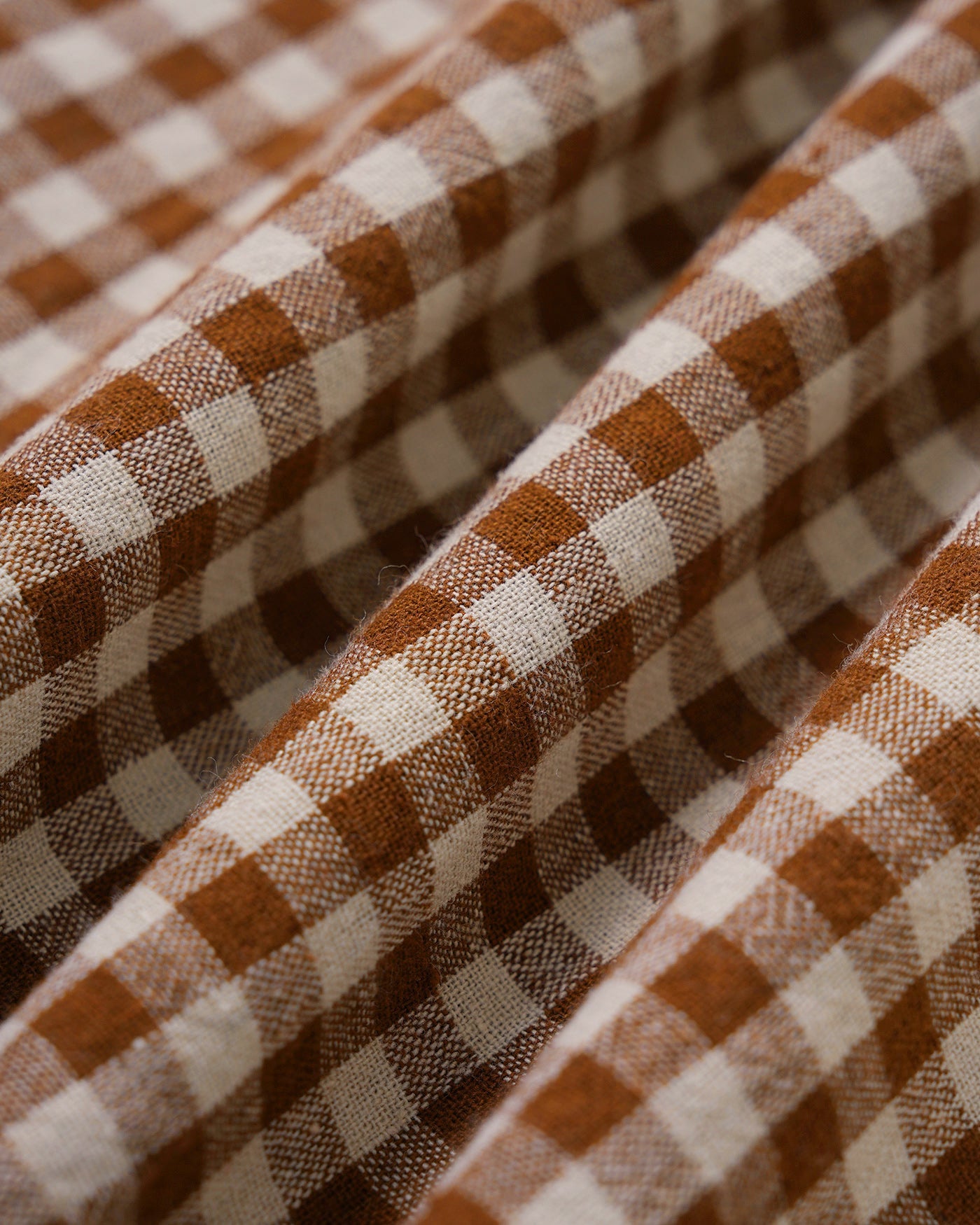 Brown Plaid Sleeveless Midi Dress" can be rewritten as "Sleeveless Midi Dress in Brown Plaid" or "Brown Plaid Midi Dress Without Sleeves.