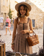 Brown Plaid Sleeveless Midi Dress" can be rewritten as "Sleeveless Midi Dress in Brown Plaid" or "Brown Plaid Midi Dress Without Sleeves.